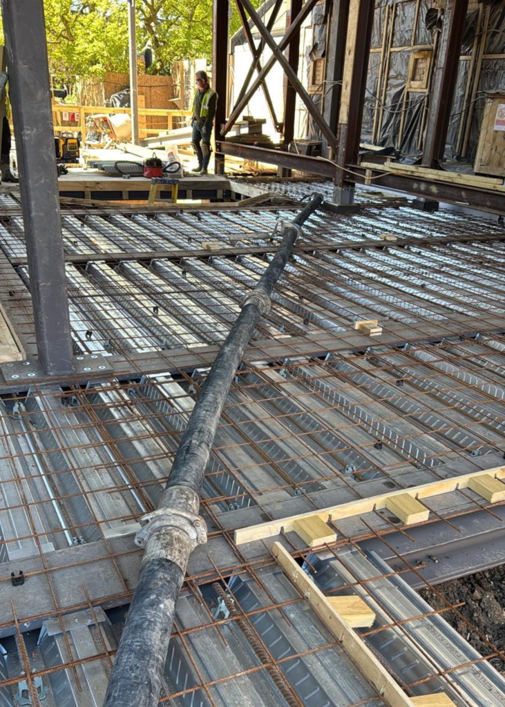 A King Concrete Pumping line pump feeding concrete on site near Wimbledon